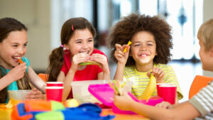 Children studying happily while eating.