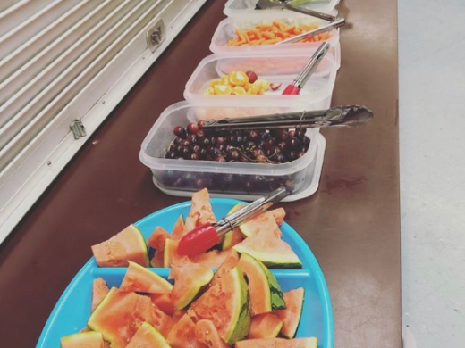 Fruits being served in plates and tiffin box