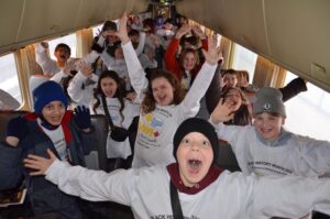 A group of happy children on a bus.