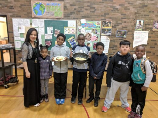 TCBC voulteers and the kids smiling with their breakfast bowls