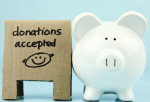 Donations Accepted sign with a piggy bank