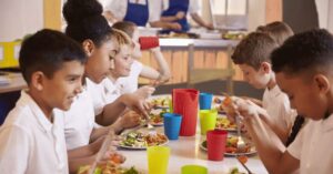 Children at The Children’s Breakfast Club enjoying a warm, nutritious meal